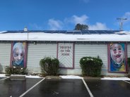 Theater on the Ridge side wall with theatrical face paintings. 