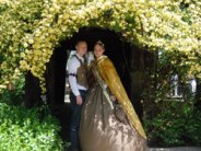 2012 Gold Nugget Queen stands under a flower awning