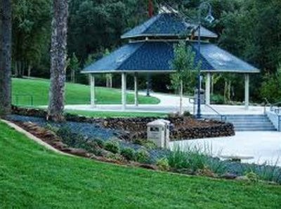 A large hexagonal pavilion steadfast in the center of the park walking path intersection