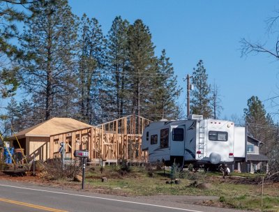 Image of RV next to home rebuild